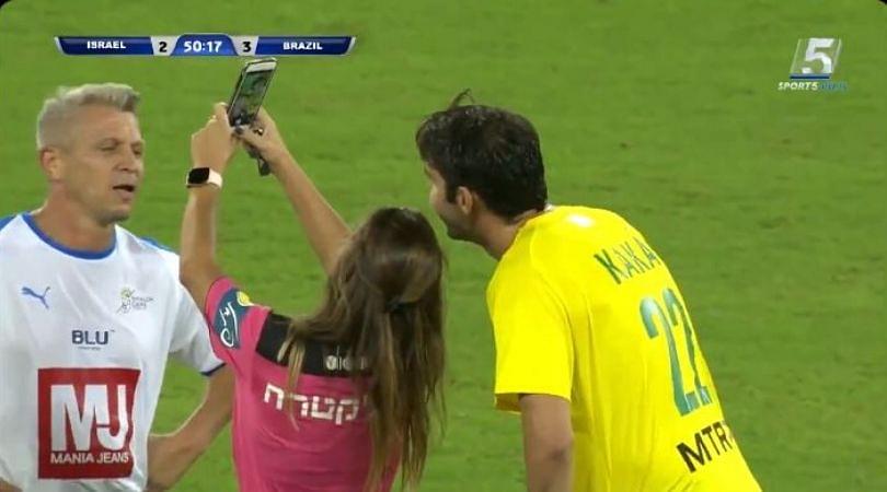 Referee shows Kaka yellow card before taking a selfie with him during a game
