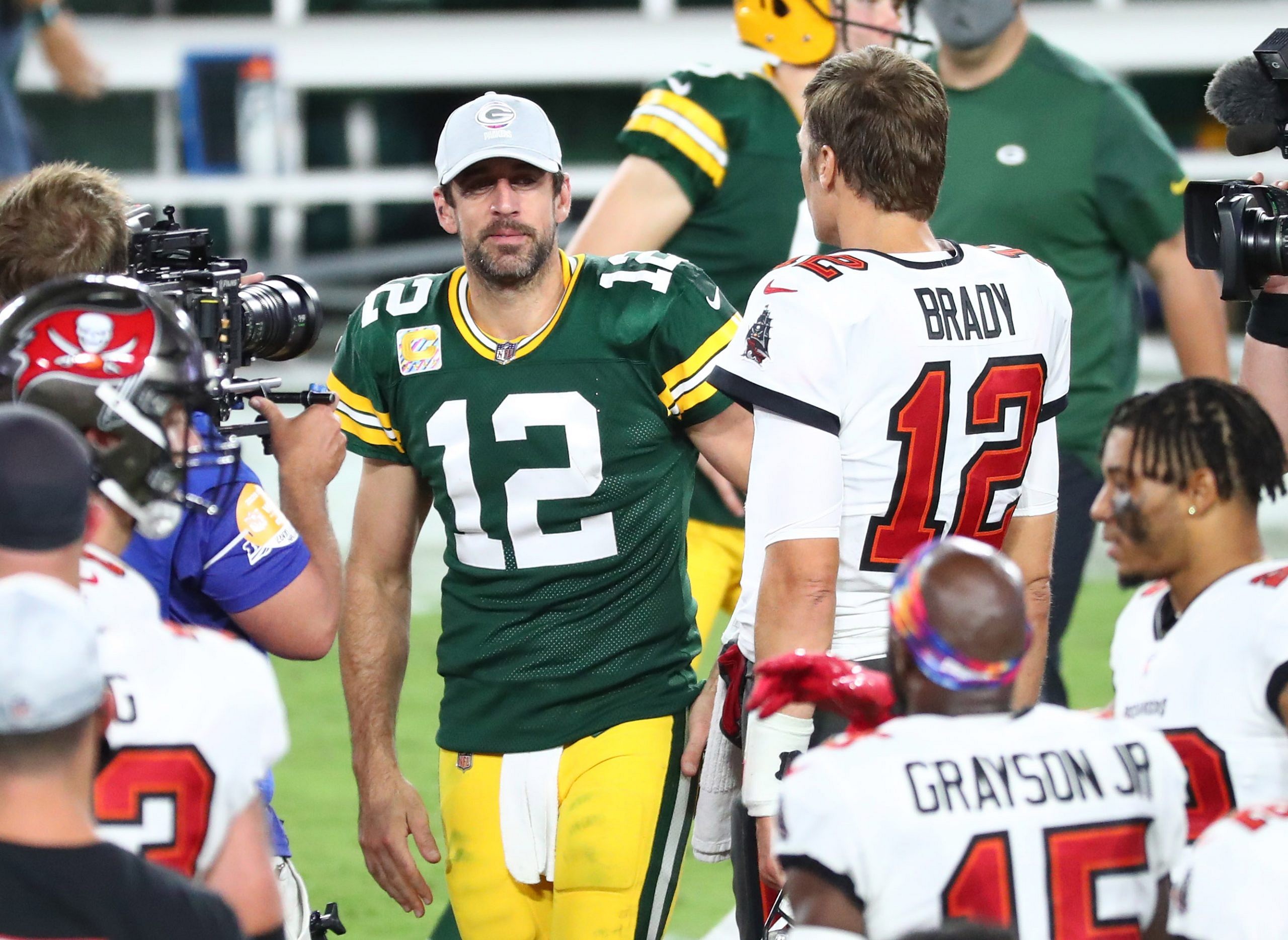 New England Patriots quarterback Tom Brady (R) hugs Green Bay Packers  quarterback Aaron Rodgers after their game at Lambeau Field on November 30,  2014 in Green Bay, Wisconsin. The Packers defeated the