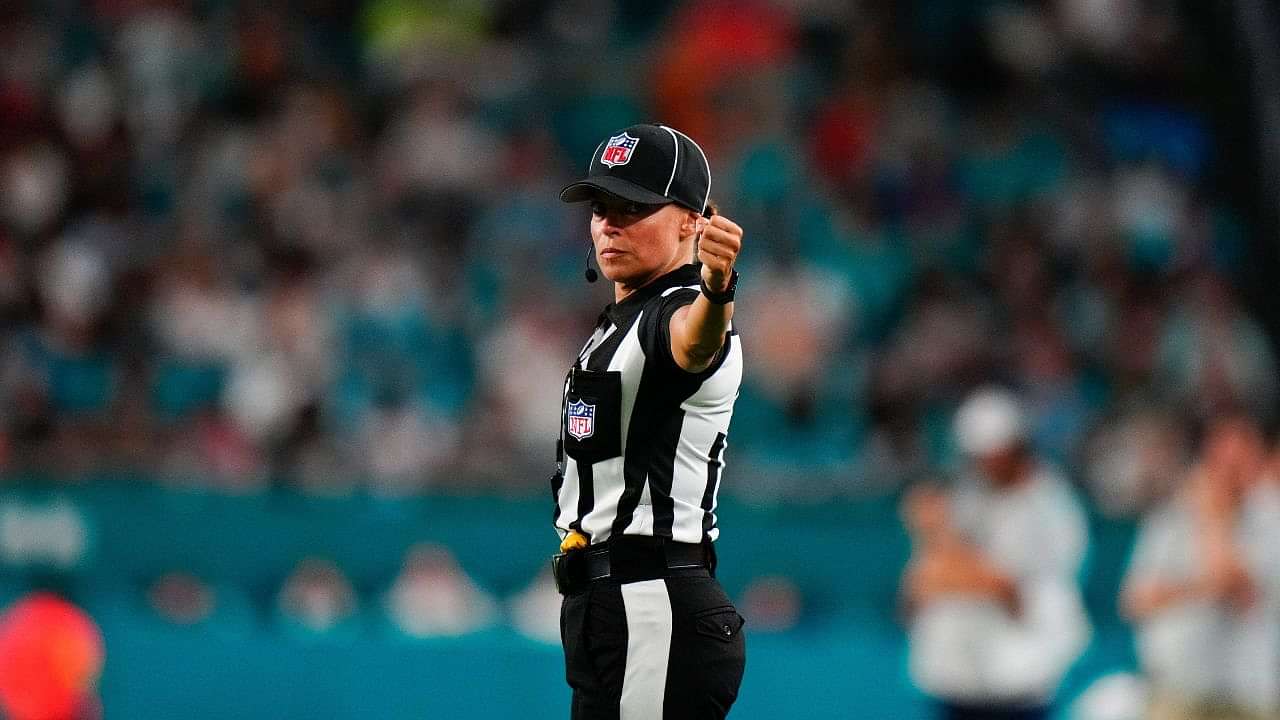 down judge Robin DeLorenzo walks the sidelines during the game