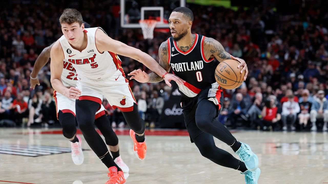 Oct 26, 2022; Portland, Oregon, USA; Portland Trail Blazers point guard Damian Lillard (0) dribbles the ball against Miami Heat forward Nikola Jovic (5) during the first half at Moda Center. Mandatory Credit: Soobum Im-USA TODAY Sports (NBA News)