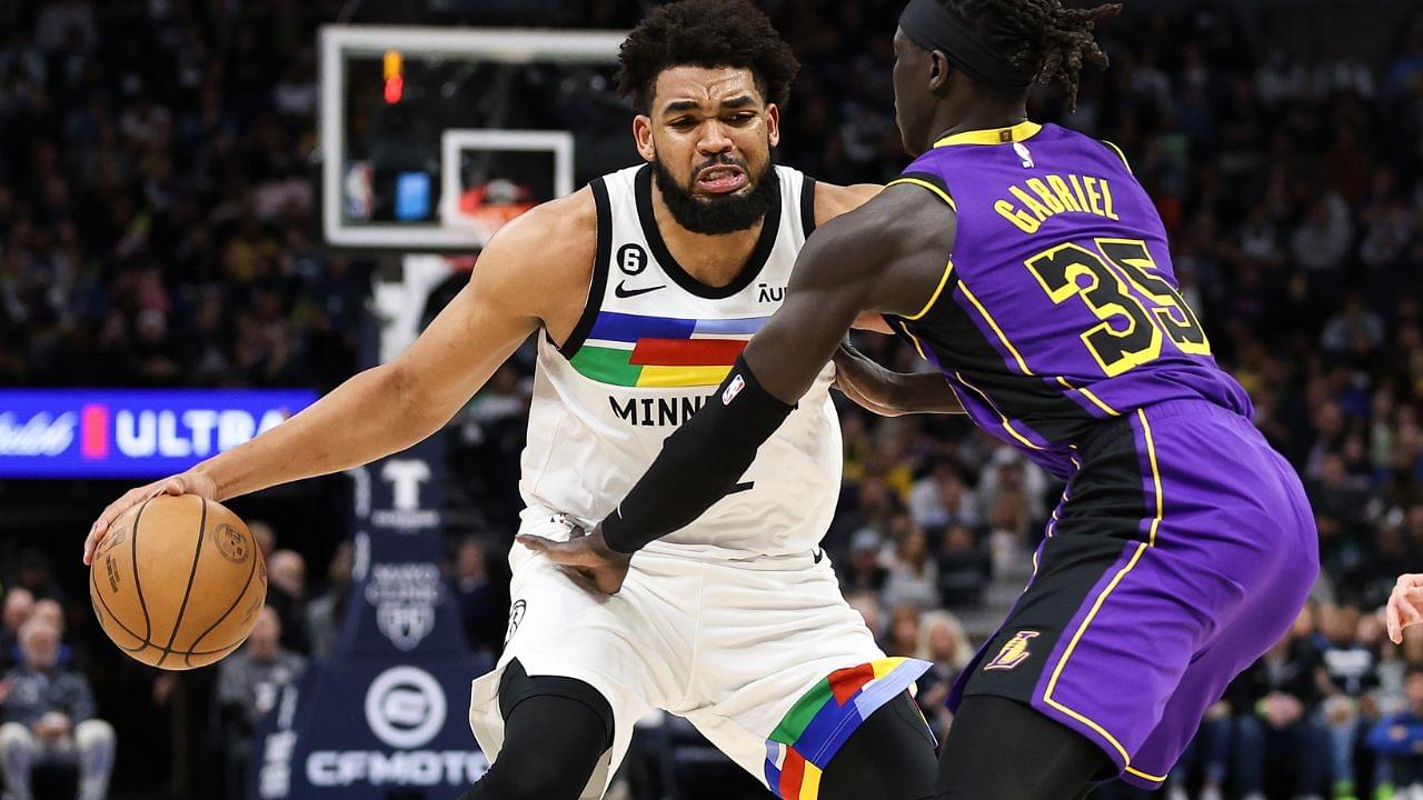 Mar 31, 2023; Minneapolis, Minnesota, USA; Minnesota Timberwolves center Karl-Anthony Towns (32) dribbles while Los Angeles Lakers forward Wenyen Gabriel (35) defends during the third quarter at Target Center. Mandatory Credit: Matt Krohn-USA TODAY Sports