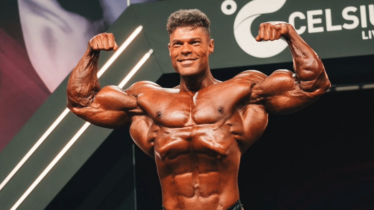 Premium Photo | High and shirtless man poses with very muscular back to the  camera. african american bodybuilder with perfect body. dark gym background.