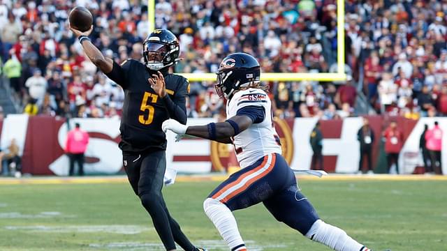 Washington Commanders quarterback Jayden Daniels (5) passes the ball as Chicago Bears defensive end Darrell Taylor (52) chases during the first quarter at Northwest Stadium.