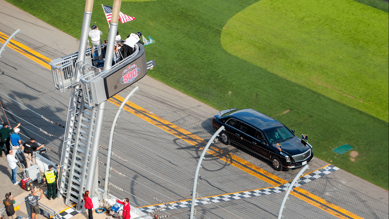 The car containing President Donald Trump crosses the start finish line as he drives on the apron of the track prior to the Daytona 500 at Daytona International Speedway.