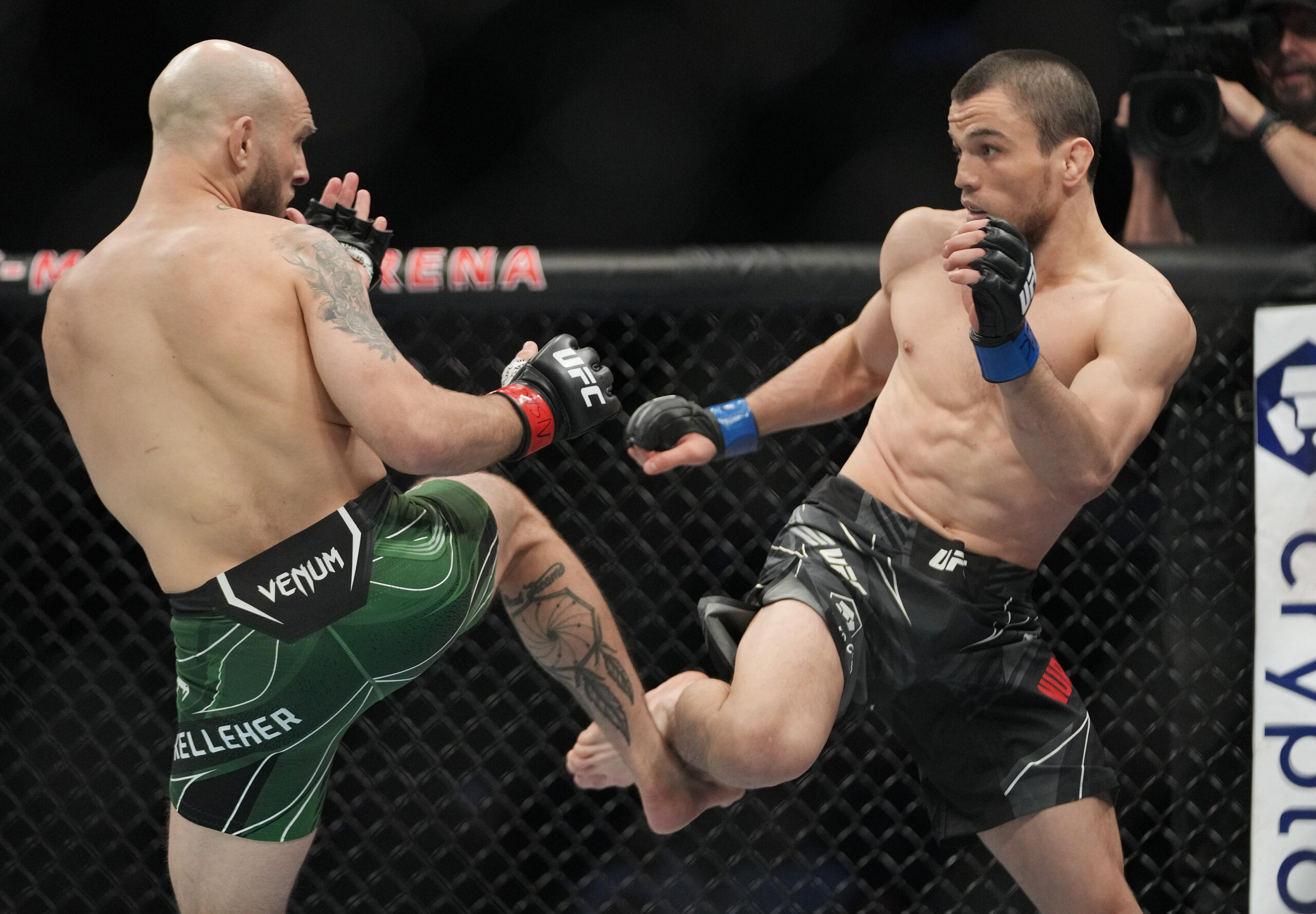 Brian Kelleher (red gloves) fights Umar Nurmagomedov (blue gloves) during UFC 272 at T-Mobile Arena.