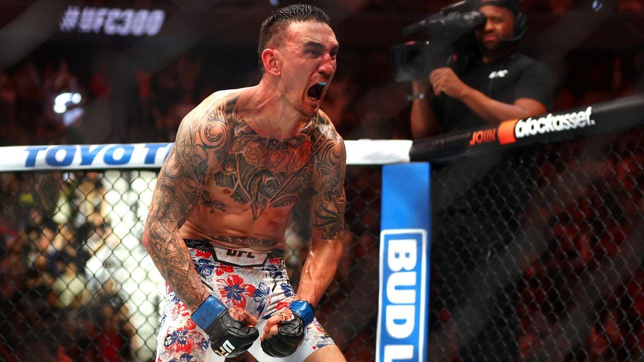 Max Holloway (blue gloves) reacts after defeating Justin Gaethje (not pictured) during UFC 300 at T-Mobile Arena.