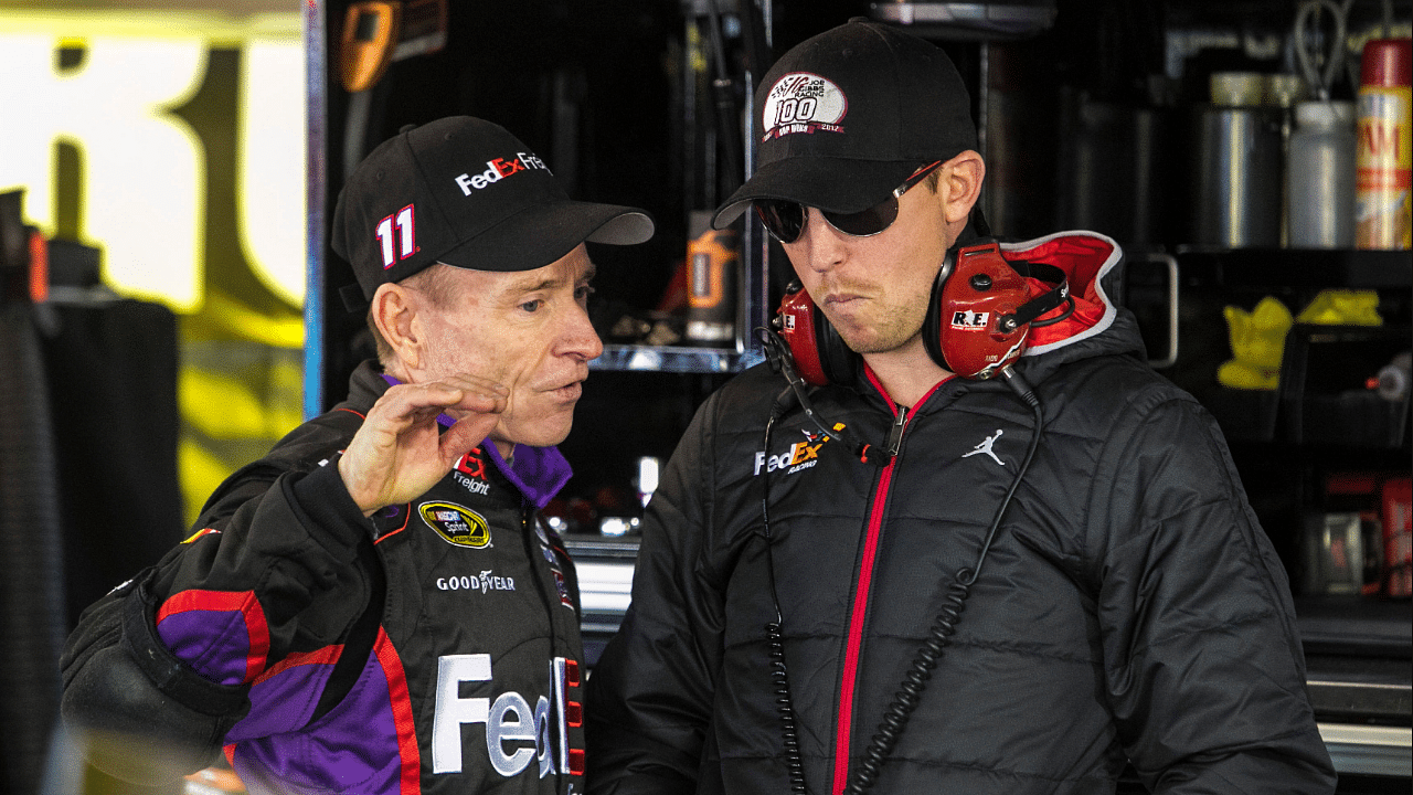 NASCAR Sprint Cup Series driver Mark Martin (11) talks with injured NASCAR Sprint Cup Series driver Denny Hamlin during practice for the STP Gas Booster 500 at Martinsville Speedway.