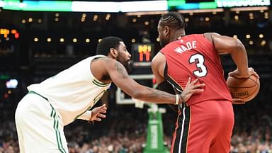 Miami Heat guard Dwyane Wade (3) controls the ball while Boston Celtics guard Kyrie Irving (11) defends during the first half at TD Garden.