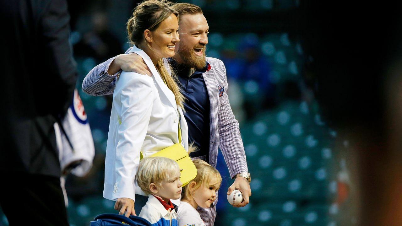 MMA fighter Conor McGregor poses for a photo with his fiance Dee Devlin, his son Conor Jack Jr., and daughter Croia after throwing out a first pitch before the game between the Chicago Cubs and the Minnesota Twins at Wrigley Field.