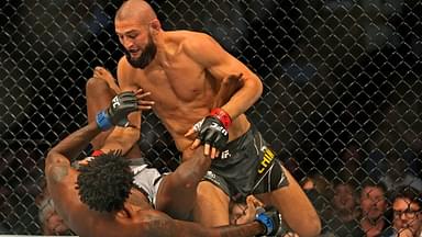 Khamzat Chimaev (red gloves) fights Kevin Holland (blue gloves) during UFC 279 at T-Mobile Arena.