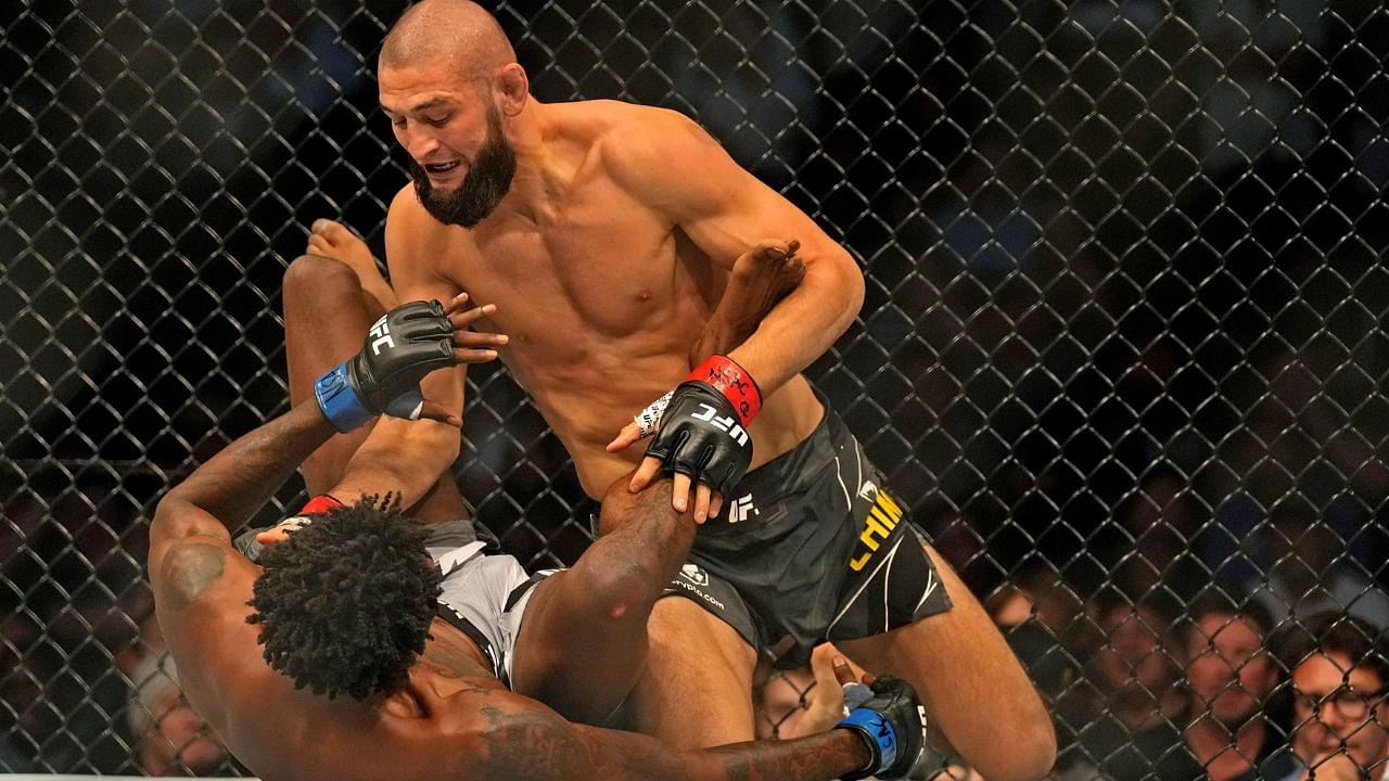 Khamzat Chimaev (red gloves) fights Kevin Holland (blue gloves) during UFC 279 at T-Mobile Arena.