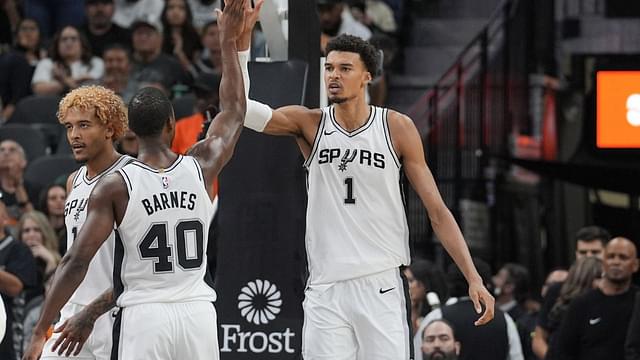 San Antonio Spurs center Victor Wembanyama (1) celebrates with San Antonio Spurs forward Harrison Barnes (40) in the first half at Frost Bank Center.