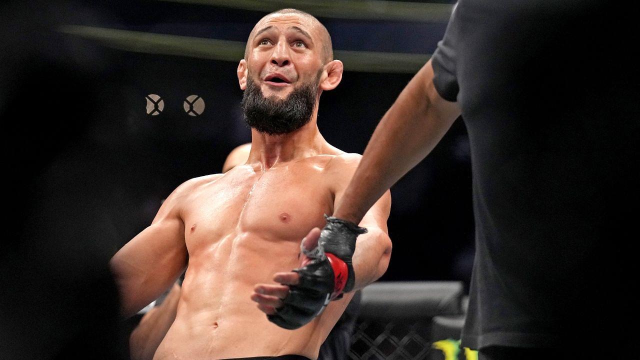 Khamzat Chimaev (red gloves) fights Kevin Holland (blue gloves) during UFC 279 at T-Mobile Arena.