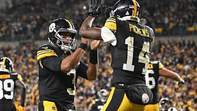 Pittsburgh Steelers wide receiver George Pickens (14) celebrates an 11 yard touchdown pass with quarterback Russell Wilson (3) iagainst the New York Jets during the second quarter at Acrisure Stadium.