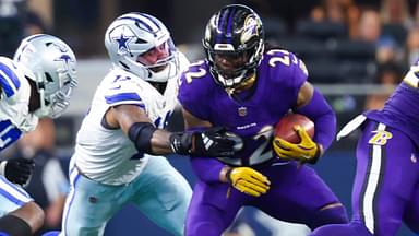 Sep 22, 2024; Arlington, Texas, USA; Baltimore Ravens running back Derrick Henry (22) runs with the ball as Dallas Cowboys linebacker Micah Parsons (11) defends during the second half at AT&T Stadium.