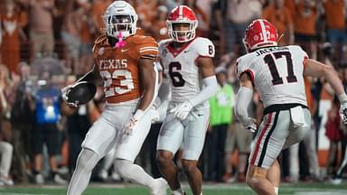 Texas Longhorns running back Jaydon Blue scores a touchdown against Georgia Bulldogs defensive back Daylen Everette (left) and defensive back Dan Jackson in the third quarter at Darrell K. Royal Texas Memorial Stadium.