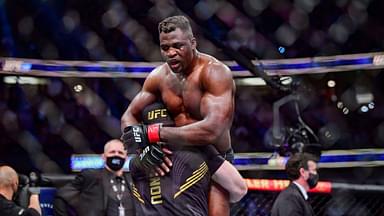 Francis Ngannou (red gloves) celebrates after the fight against Ciryl Gane (blue gloves) during UFC 270 at Honda Center.