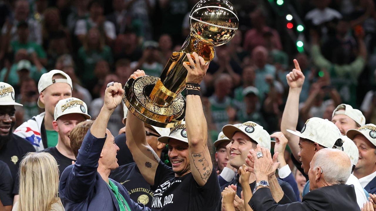 Boston Celtics head coach Joe Mazzulla holds up the trophy as he celebrates after winning the 2024 NBA Finals against the Dallas Mavericks at TD Garden.