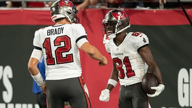 Sep 9, 2021; Tampa, Florida, USA; Tampa Bay Buccaneers quarterback Tom Brady (12) and wide receiver Antonio Brown (81) celebrate after a touchdown against the Dallas Cowboys in the second quarter at Raymond James Stadium.