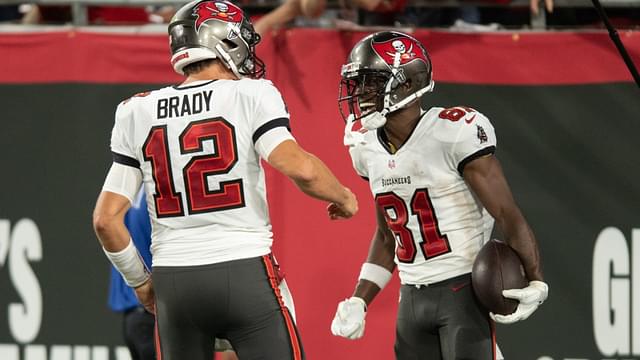 Sep 9, 2021; Tampa, Florida, USA; Tampa Bay Buccaneers quarterback Tom Brady (12) and wide receiver Antonio Brown (81) celebrate after a touchdown against the Dallas Cowboys in the second quarter at Raymond James Stadium.