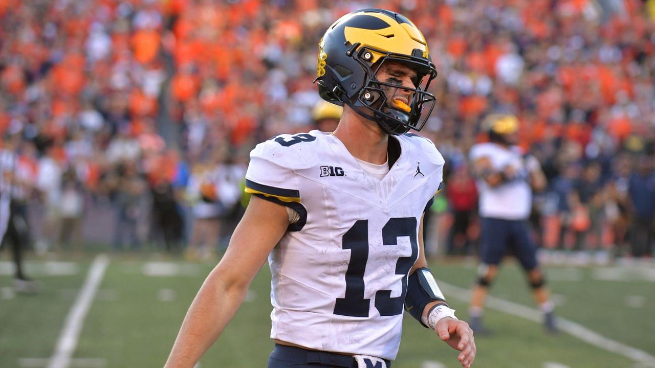 Michigan Wolverines quarterback Jack Tuttle (13) reacts after turning over possession of the ball against the Illinois Fighting Illini during the second half at Memorial Stadium