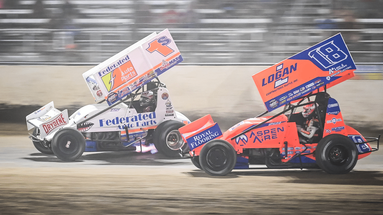 Logan Schuchart (1s) and Giovanni Scelzi (18) race down the front straight in the World of Outlaws Larry Hillerud Badger 40 on Friday, July 12, 2024, at the Wilmot Raceway in Wilmot, Wisconsin.