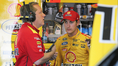 NASCAR Sprint Cup Series driver Joey Logano (right) talks to crew chief Todd Gordon (left) during practice for the Windows 10 400 at Pocono Raceway.