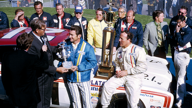 NASCAR Grand National Series driver Bobby Allison (left) receives the most popular driver award as A.J. Foyt (right) celebrates in victory lane after winning the inaugural 1971 Miller High Life 500 at Ontario Motor Speedway.