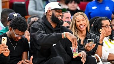 Los Angeles Laker LeBron James and his wife Savannah James sit court side at the McDonald's All American game during the first half at Toyota Center.