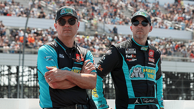 NASCAR Cup Series driver Denny Hamlin (right) stands with his crew chief Chris Gabehart (left) on pit road prior to The Great American Getaway 400 at Pocono Raceway.