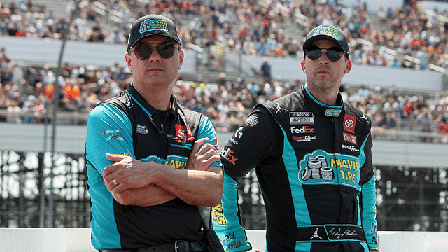 NASCAR Cup Series driver Denny Hamlin (right) stands with his crew chief Chris Gabehart (left) on pit road prior to The Great American Getaway 400 at Pocono Raceway.