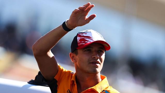 Lando Norris waves to fans during the driver's parade