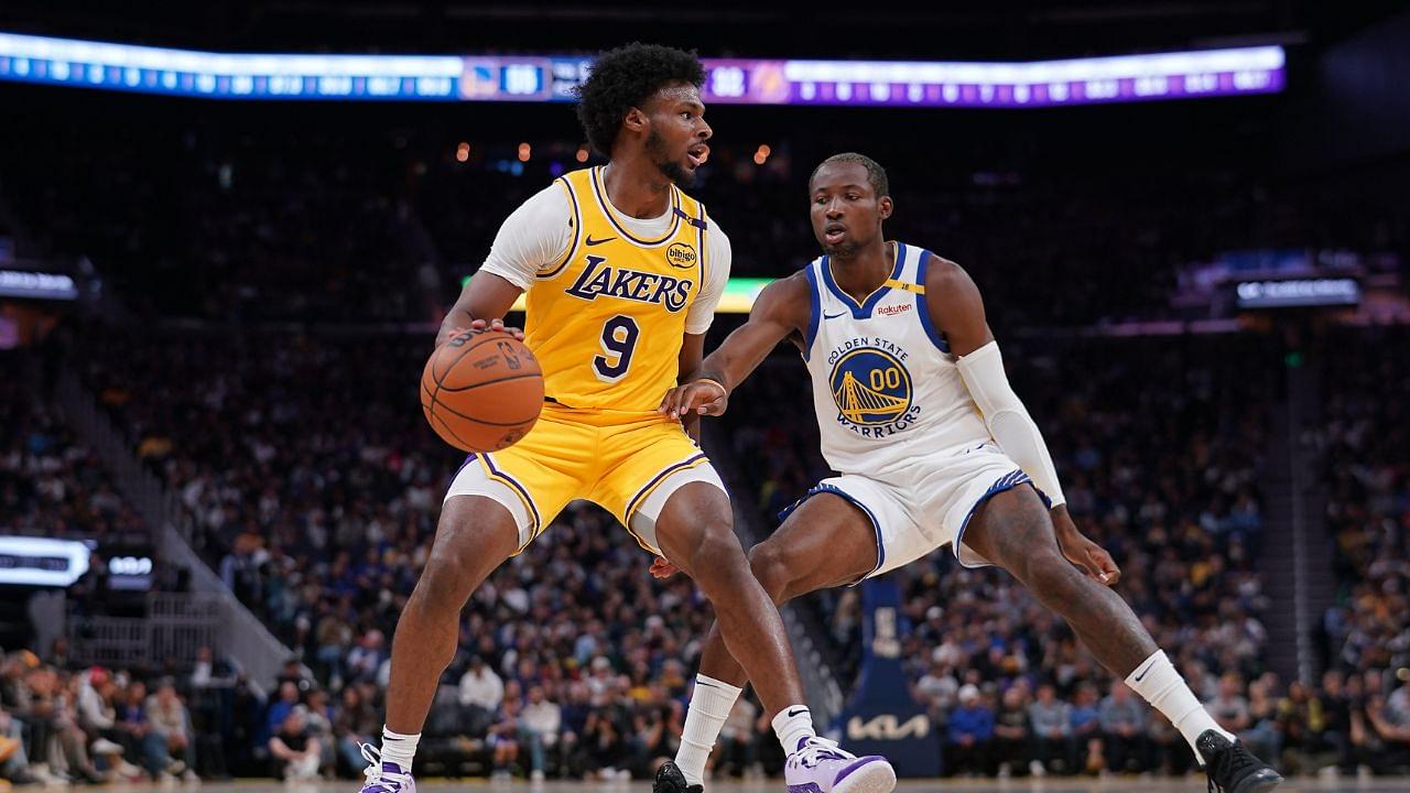 Los Angeles Lakers guard Bronny James (9) dribbles the ball next to Golden State Warriors forward Jonathan Kuminga (00) in the second quarter at the Chase Center.