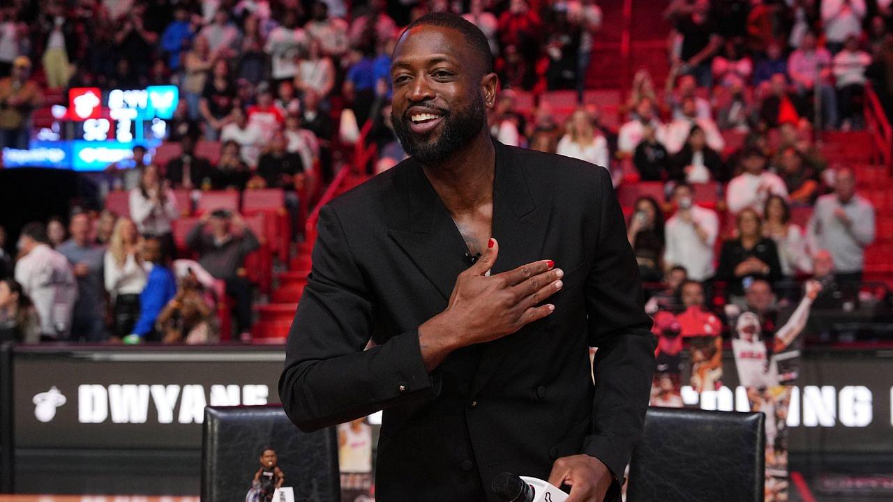 Former Miami Heat player Dwayne Wade acknowledges the fans and cameras after a special ceremony during halftime of the game between the Miami Heat and the Charlotte Hornets at Kaseya Center.