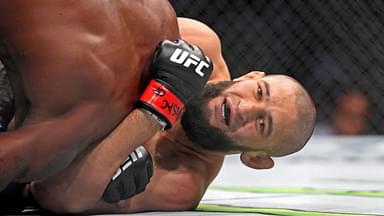 Khamzat Chimaev (red gloves) fights Kevin Holland (blue gloves) during UFC 279 at T-Mobile Arena.