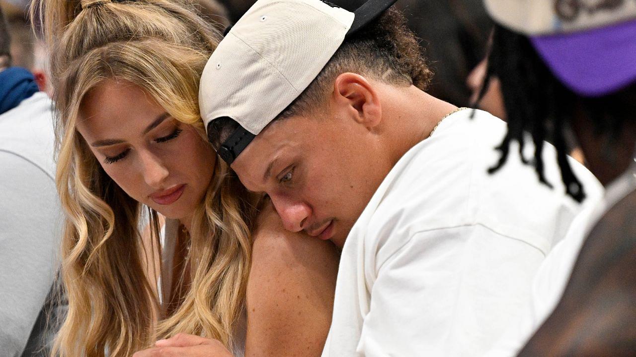 Kansas City Chiefs quarterback Patrick Mahomes (right) and his wife Brittany Mahomes (left) check their phone during the second half of the game between the Dallas Mavericks and the Minnesota Timberwolves in game three of the western conference finals for the 2024 NBA playoffs at American Airlines Center.