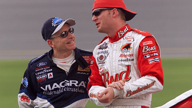 Mark Martin talks with Dale Earnhardt Jr. just before their qualifying runs were called off due to rain Friday afternoon, July 6, 2001 at the Daytona International Speedway.