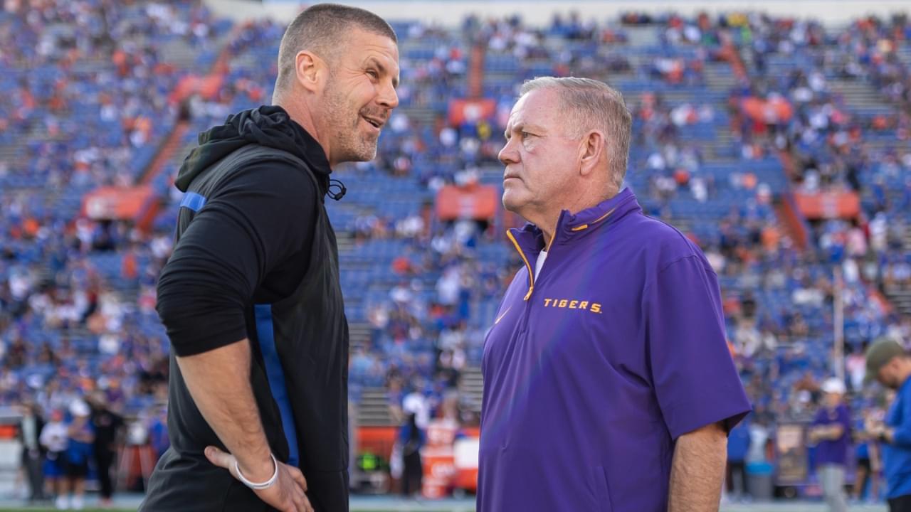 Nov 16, 2024; Gainesville, Florida, USA; Florida Gators head coach Billy Napier and LSU Tigers head coach Brian Kelly talk midfield before a game at Ben Hill Griffin Stadium.