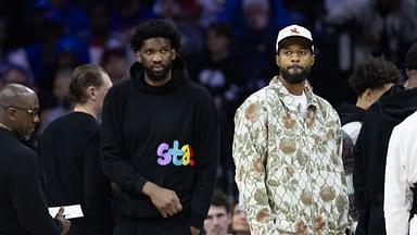 Injured Philadelphia 76ers Paul George (R) and Joel Embiid (L) look on during the first quarter against the Memphis Grizzlies at Wells Fargo Center.