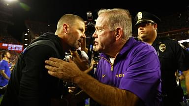 LSU Tigers head coach Brian Kelly and Florida Gators head coach Billy Napier greet after the game at Ben Hill Griffin Stadium.