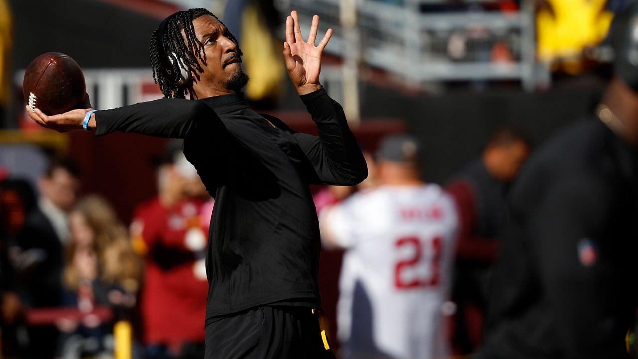 Washington Commanders quarterback Jayden Daniels warms up prior to putting on pads before the game against the Chicago Bears at Commanders Field.