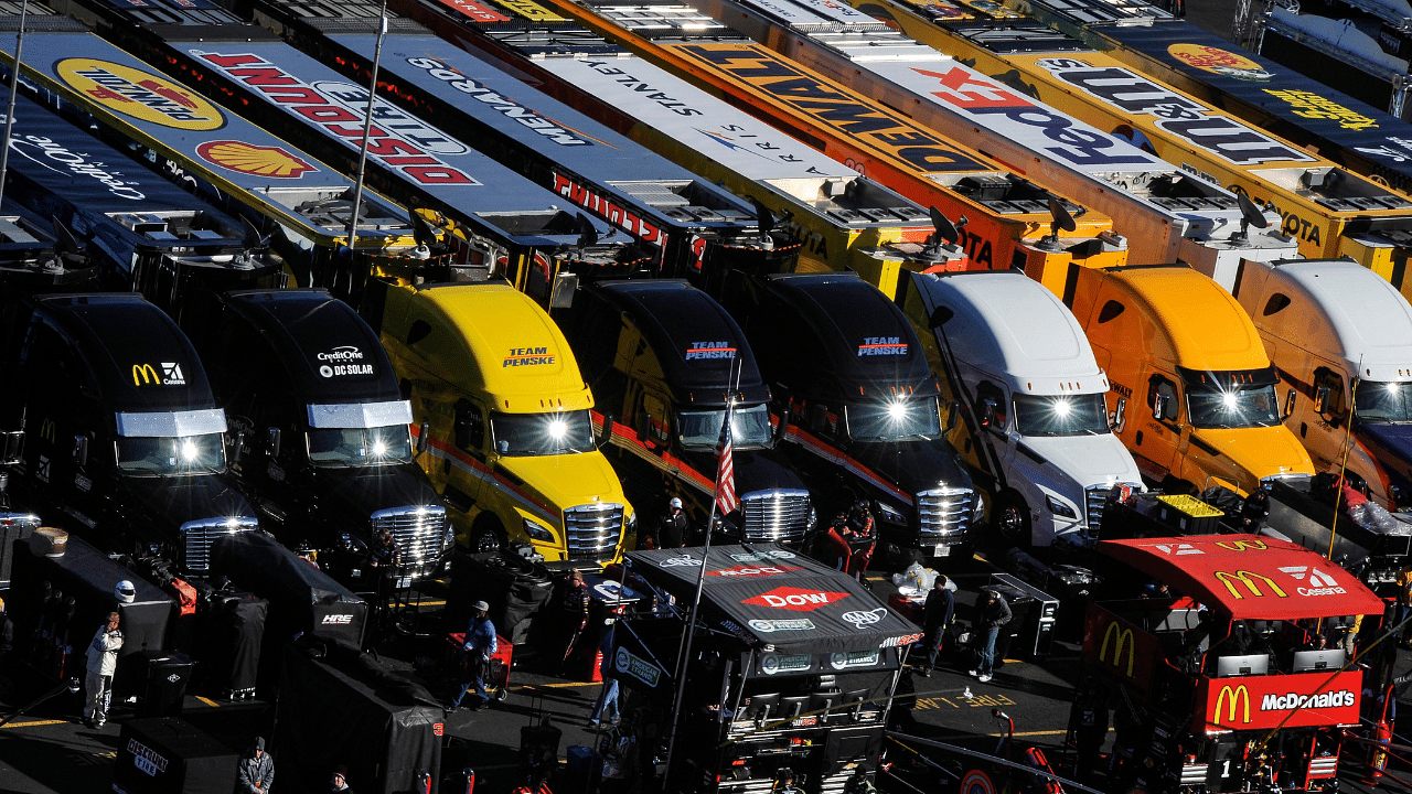 The sun is reflected in the windshields of several Monster Energy NASCAR Cup Series haulers during the STP 500 at Martinsville Speedway.