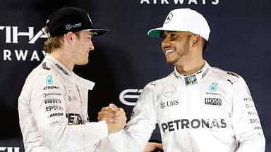 Mercedes Formula One driver Nico Rosberg (L) of Germany shakes hands with Lewis Hamilton of Britain