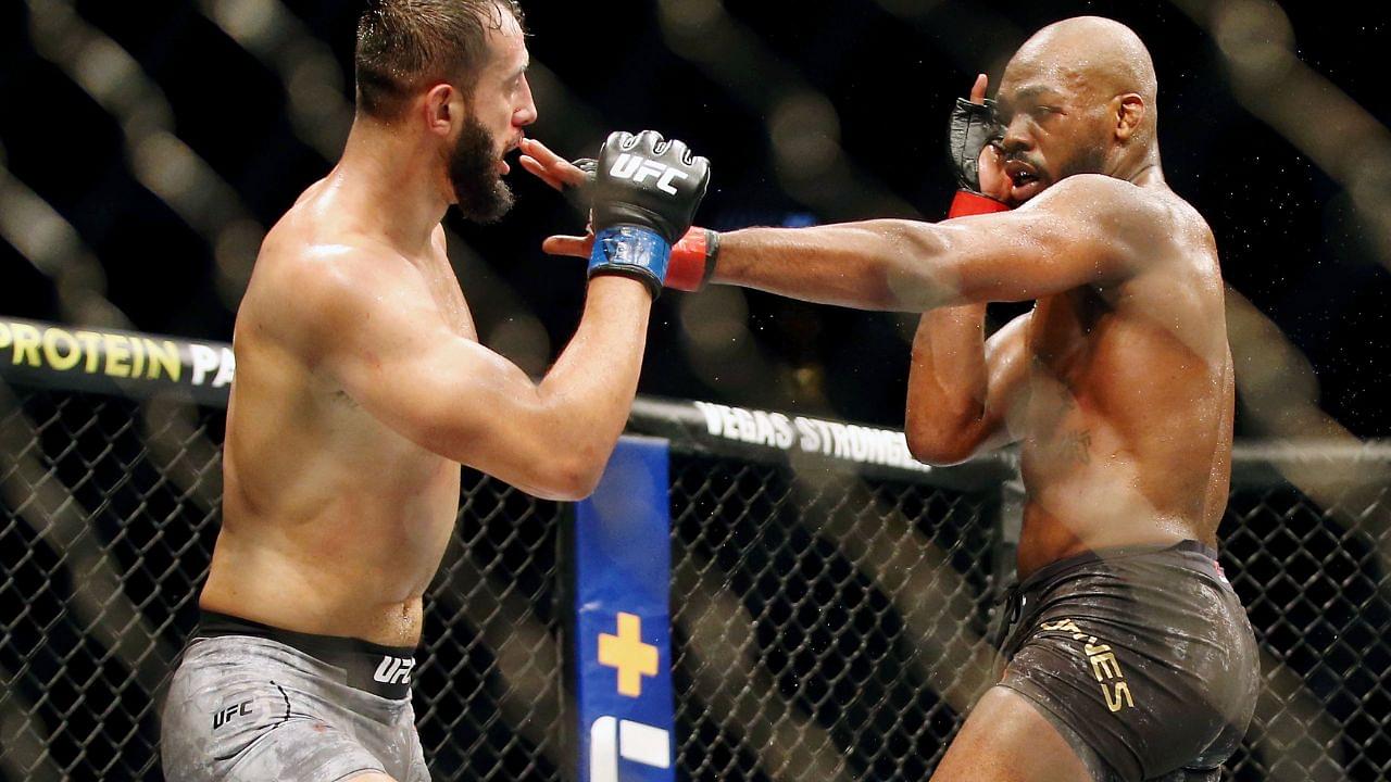 Jon Jones (red gloves) fights Dominick Reyes (blue gloves) during UFC 247 at Toyota Center.