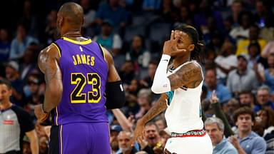 Memphis Grizzlies guard Ja Morant (12) reacts toward Los Angeles Lakers forward LeBron James (23) after a three point basket during the first half at FedExForum.