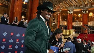 Former NFL quarterback Cam Newton stands on the red carpet ahead of the 2024 NFL Draft at Detroit’s Fox Theatre.