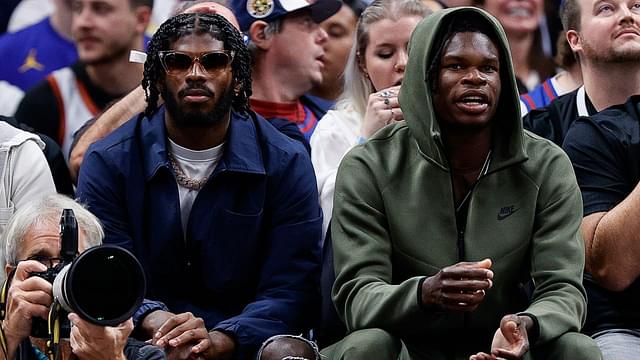 University of Colorado Buffaloes football players Shedeur Sanders (L) and Travis Hunter (R) watch during the third period between the Denver Nuggets and the Los Angeles Lakers at Ball Arena.