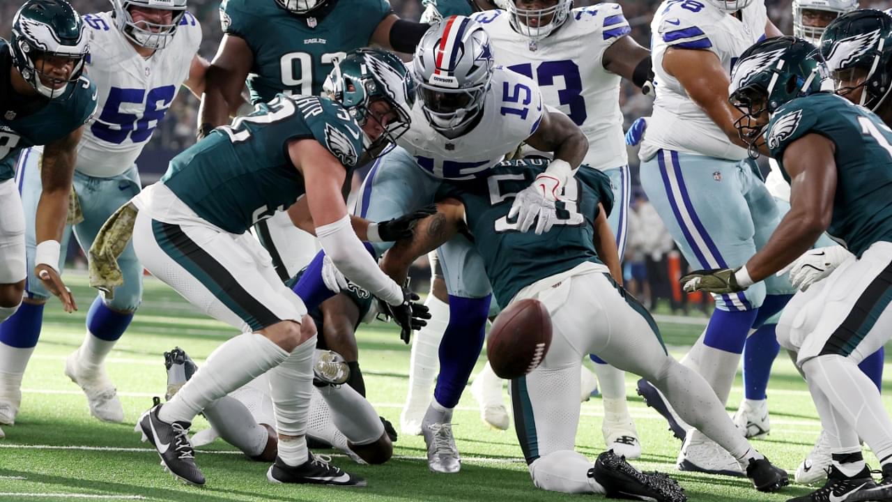 Nov 10, 2024; Arlington, Texas, USA; Dallas Cowboys running back Ezekiel Elliott (15) fumbles the ball after bring hit by Philadelphia Eagles cornerback Cooper DeJean (33) in the second quarter at AT&T Stadium.