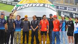 The Formula 1 drivers pose in front of a large helmet by Ayrton Senna Forever Senna Sao Paulo