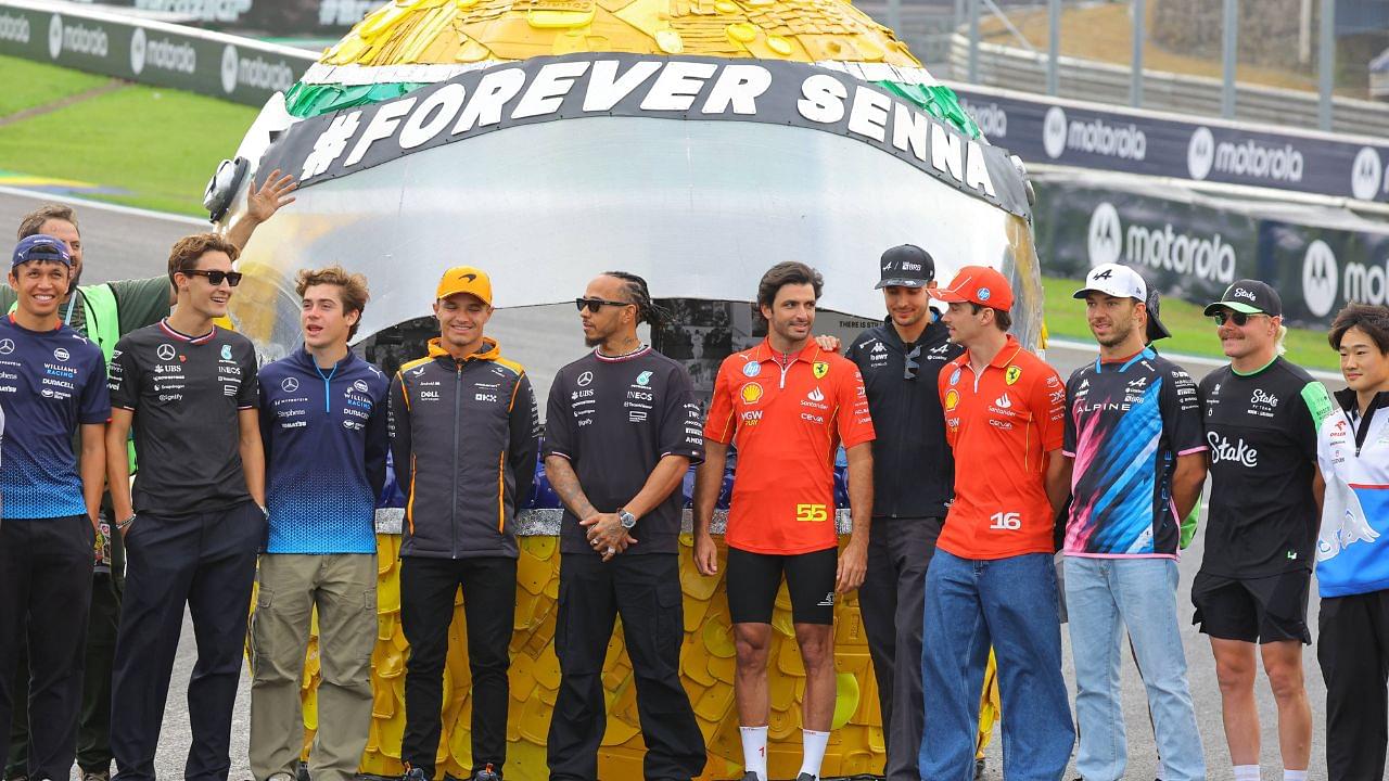 The Formula 1 drivers pose in front of a large helmet by Ayrton Senna Forever Senna Sao Paulo